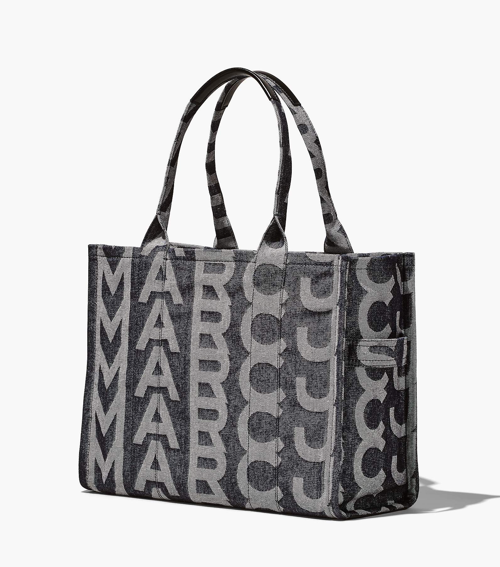 THE Monogram Denim Tote bag; returns on premium italian denim tote. The  large-scale font placement offers a bold take on our namesake…